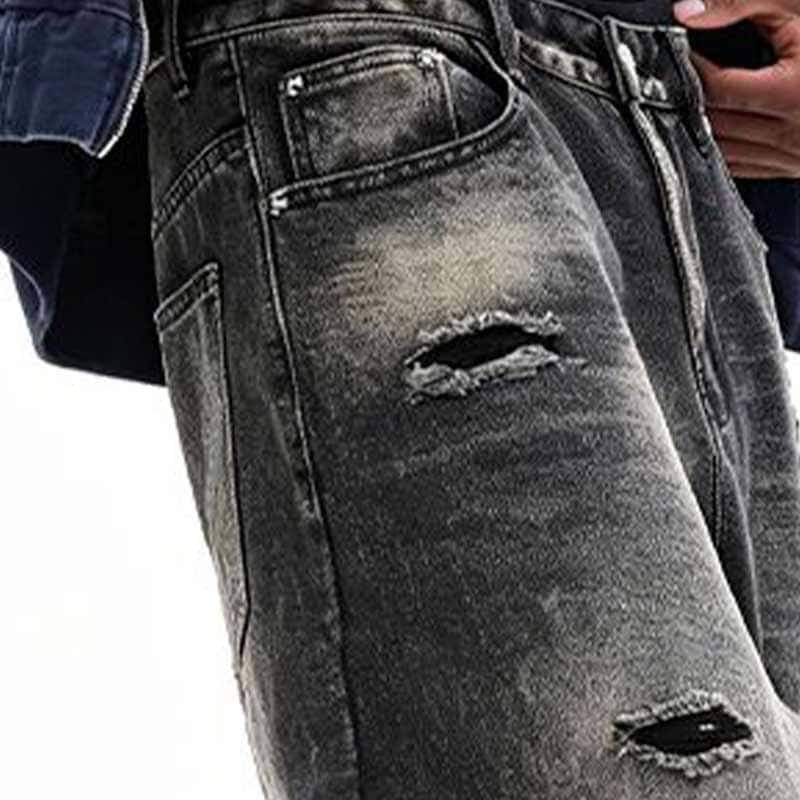thigh close-up detail, heavy wash denim fabric texture and frayed destroyed cut work