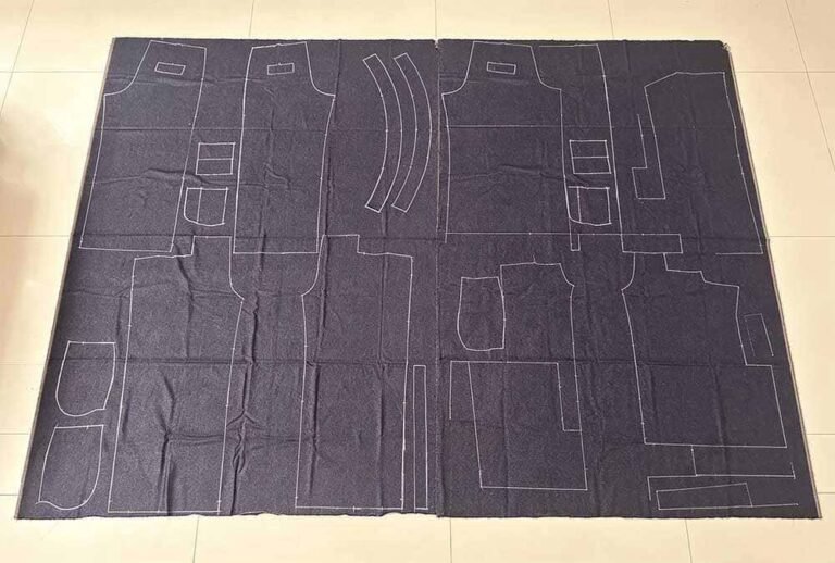 denim factory production workflow, merchandiser prepares production pack and denim fabric roll pre-wash testing before jean fabric cutting