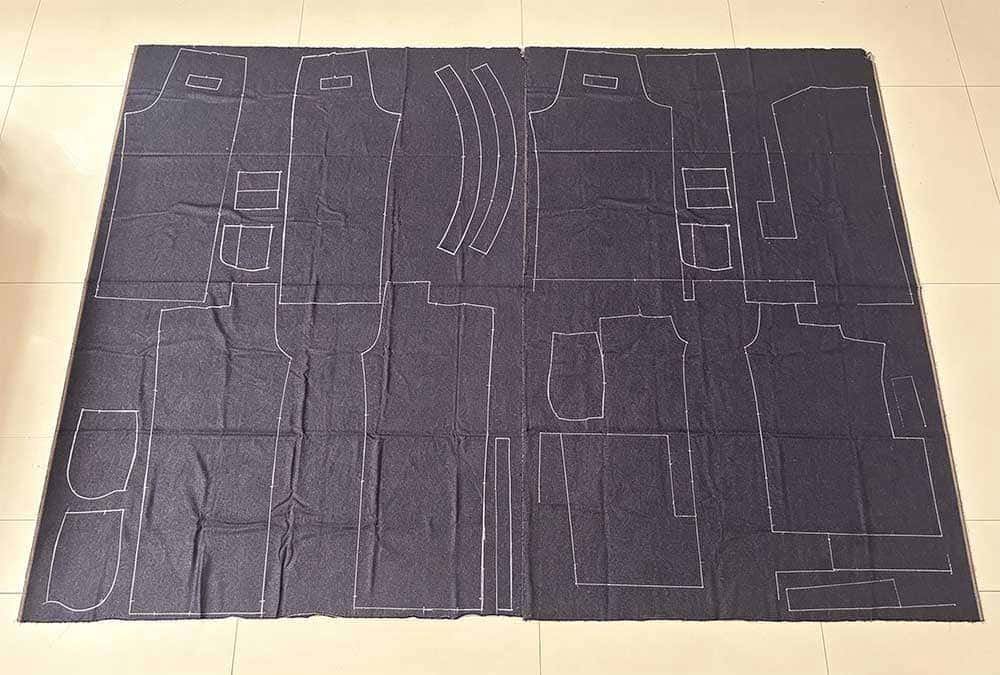 denim factory production workflow, merchandiser prepares production pack and denim fabric roll pre-wash testing before jean fabric cutting