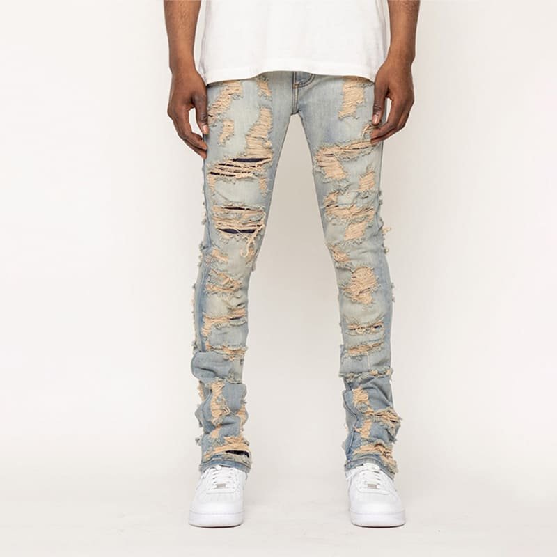 front full-length heavy cotton jeans, all-over shredded surface distressing and sand wash gradients