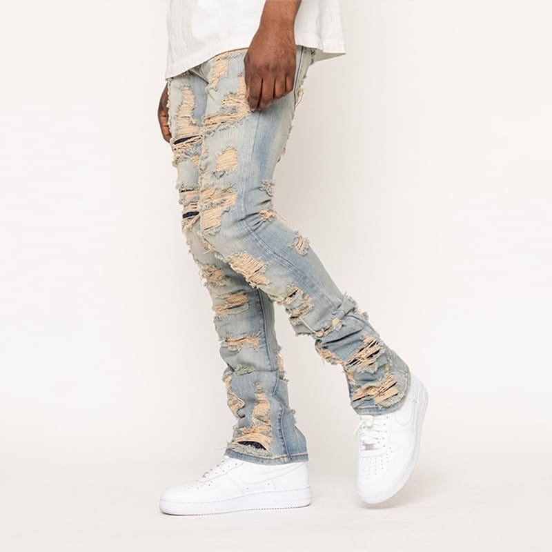 dynamic side pose denim, textured frayed rips along stretch cotton tailored leg silhouette