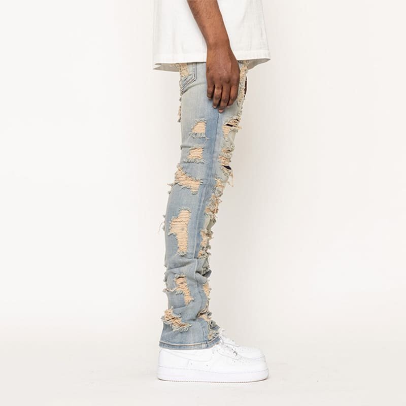 static profile view denim, scattered distressed rips on soft sand washed elastic woven material