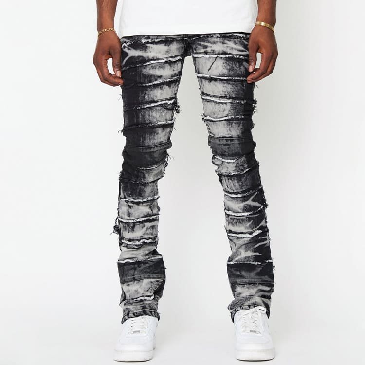 straight front shot of spliced denim pants, wavy mottled tie wash across thigh and lower leg stretch panels