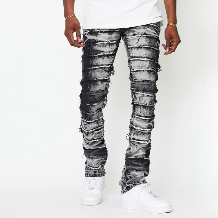 walking motion shot of skinny stretch spliced panel denim pants, showing fabric drape & raw edge movement effect