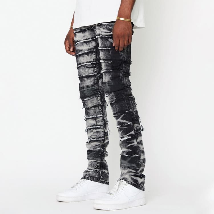 45-degree front view of spliced panel denim pants, multi-piece assembly and enzyme bleaching colour rendering effect