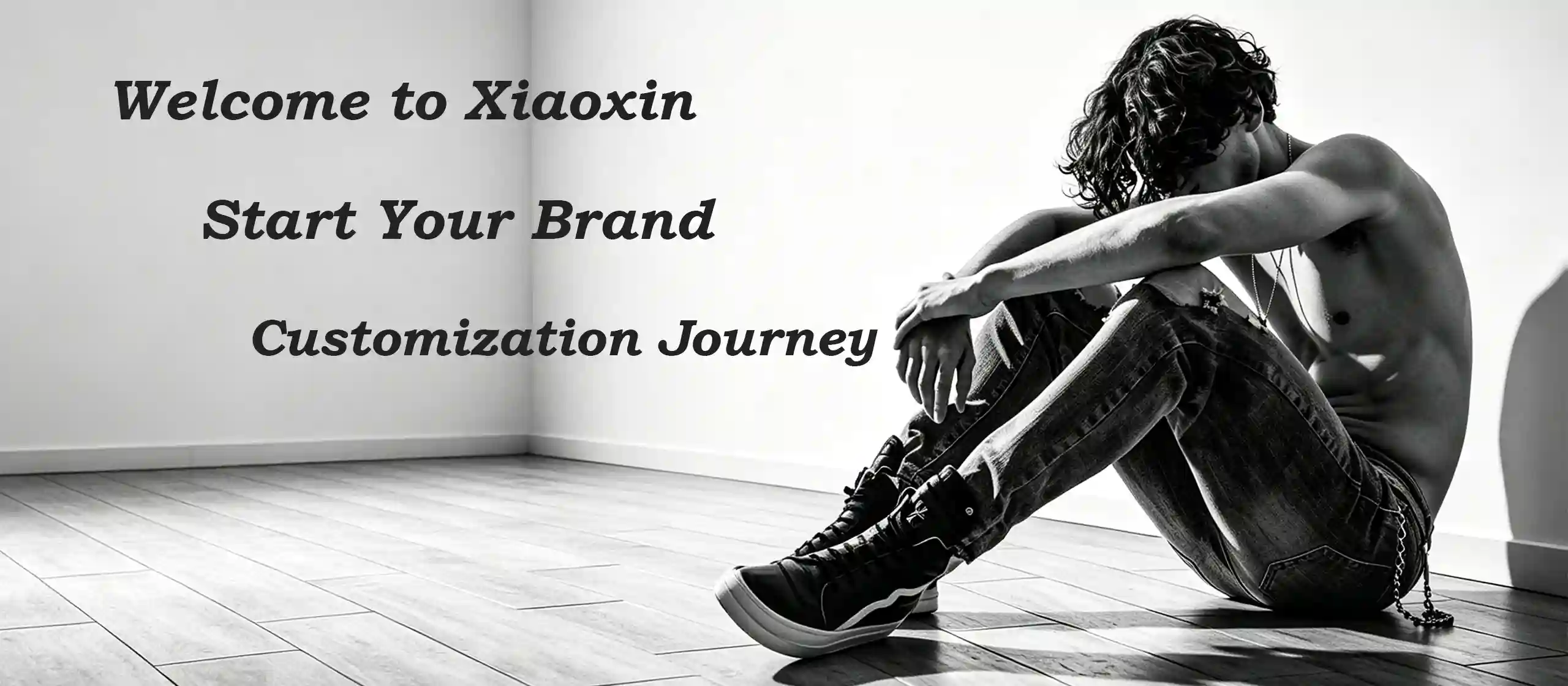 xiaoxin clothing custom garment manufacturing factory, focusing on denim OEM jeans and ODM service, black white homepage banner with male model in denim